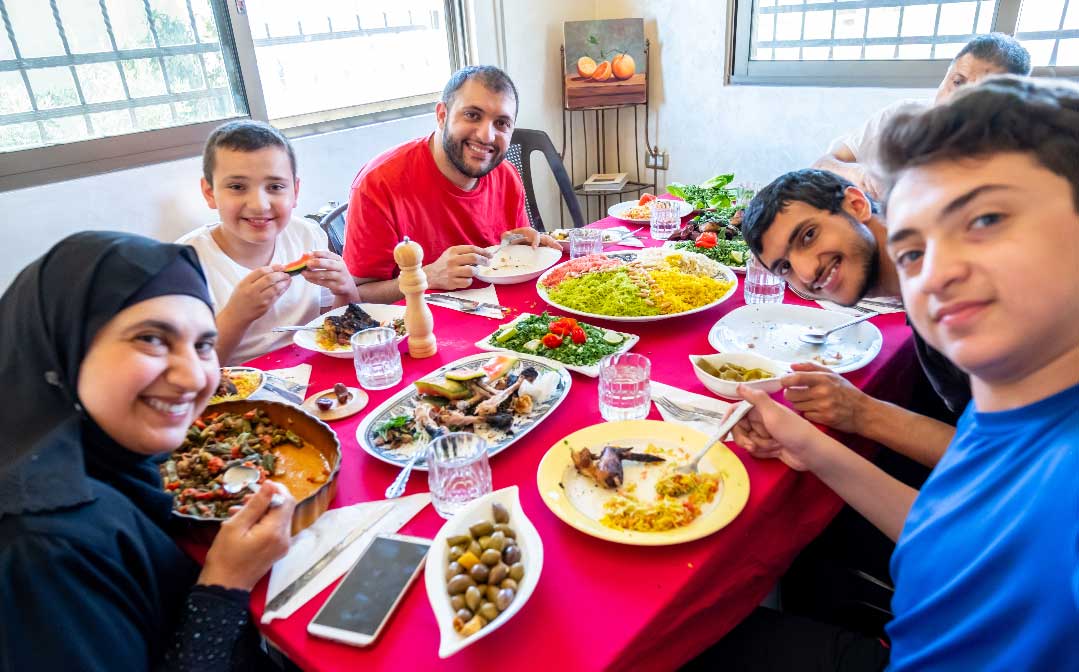 A family around a dining table.