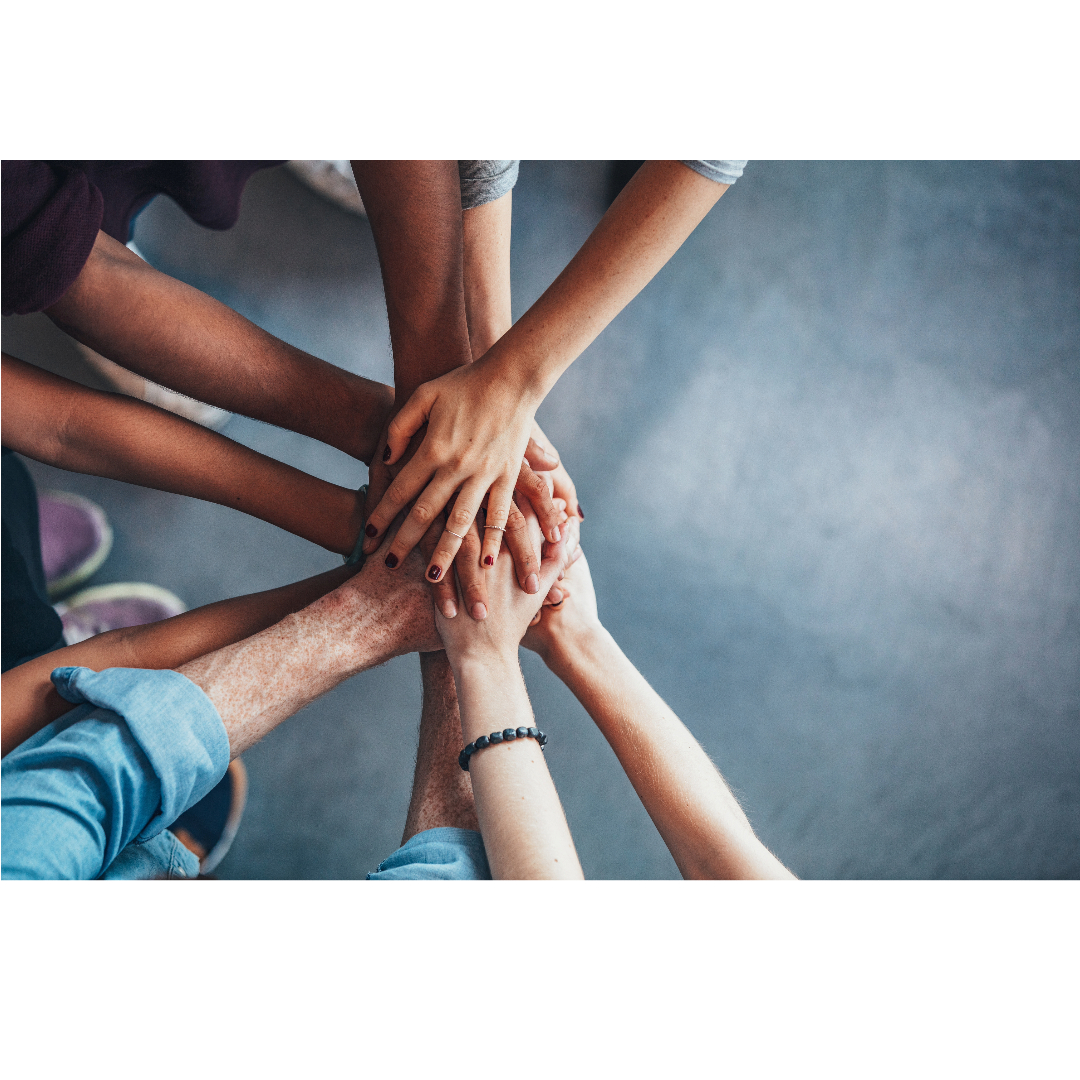 Image of many hands on top of each other symbolizing tight relationships.